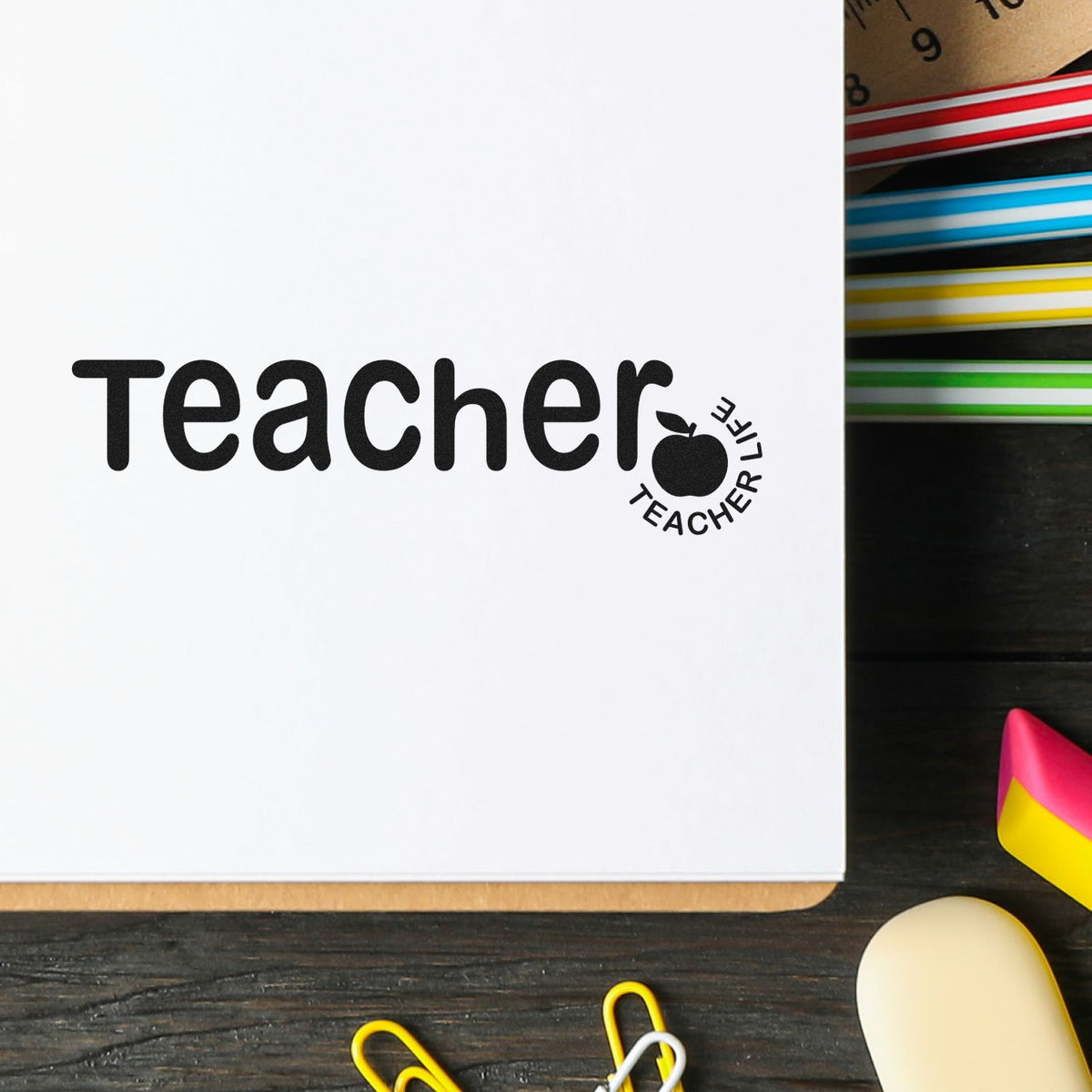 Teacher Life rubber stamp on a notebook with colorful school supplies