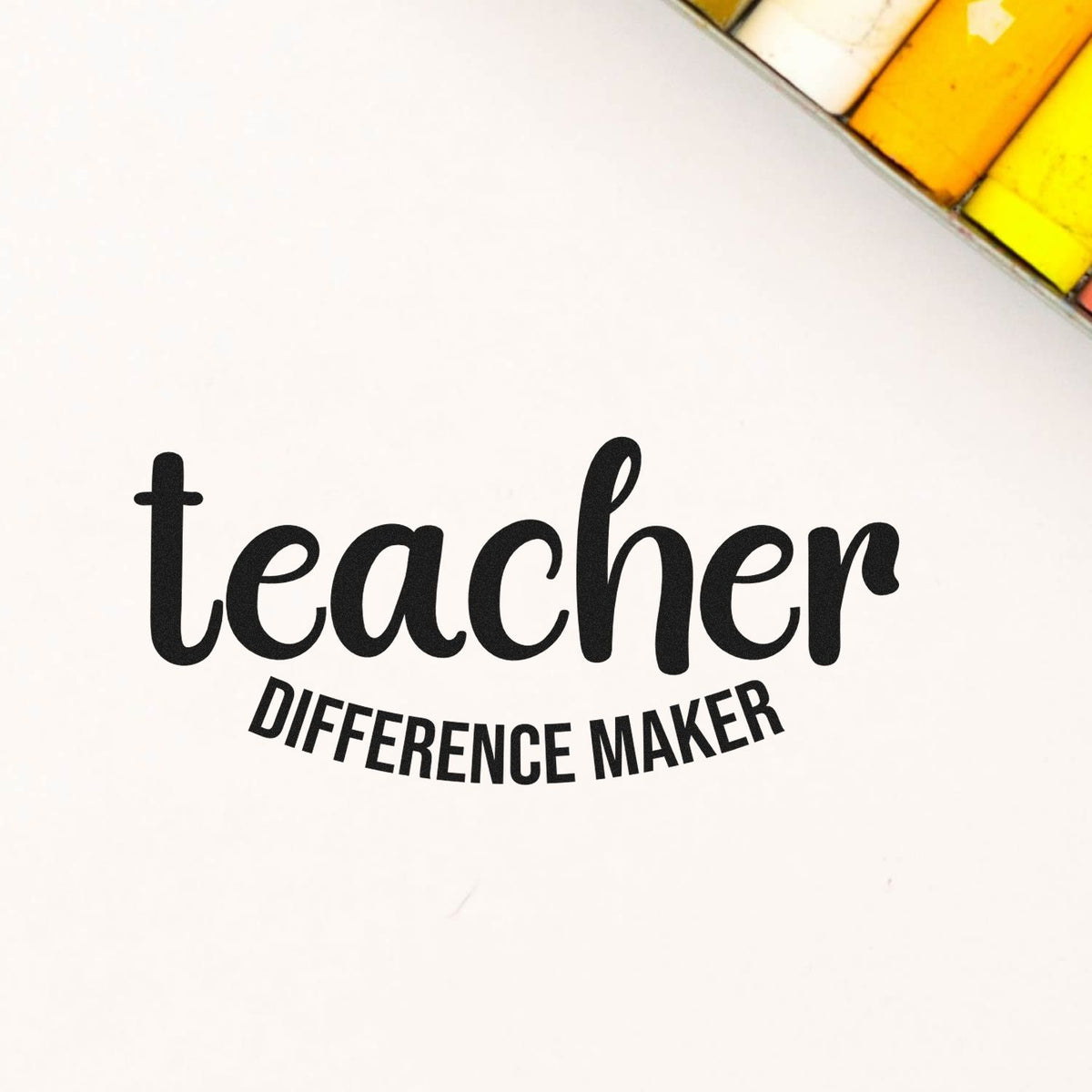 Teacher rubber stamp design reading teacher difference maker on a clean white background.