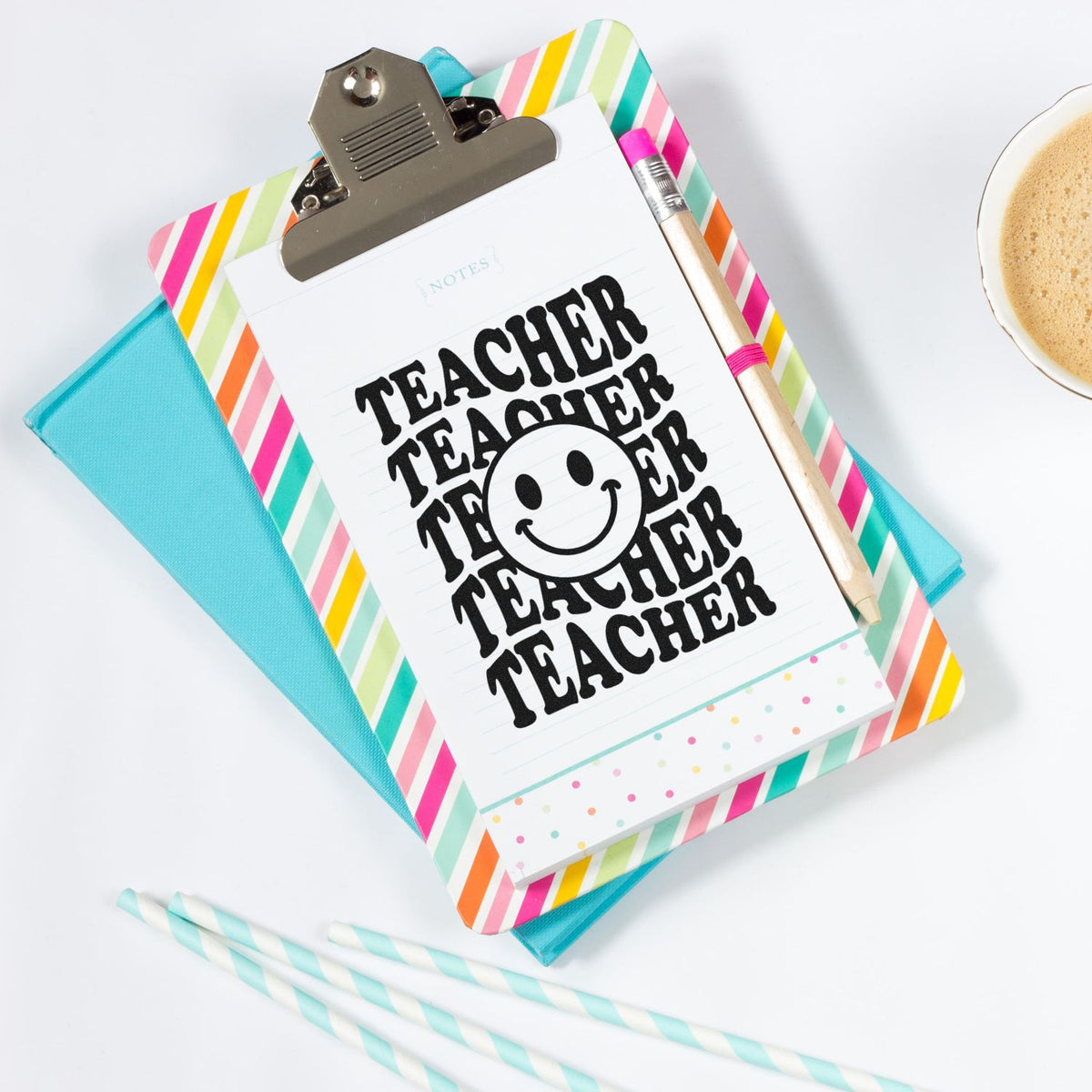 Teacher rubber stamp graphic on clipboard with colorful stationery, ideal for classroom notes, planner use, and crafts.