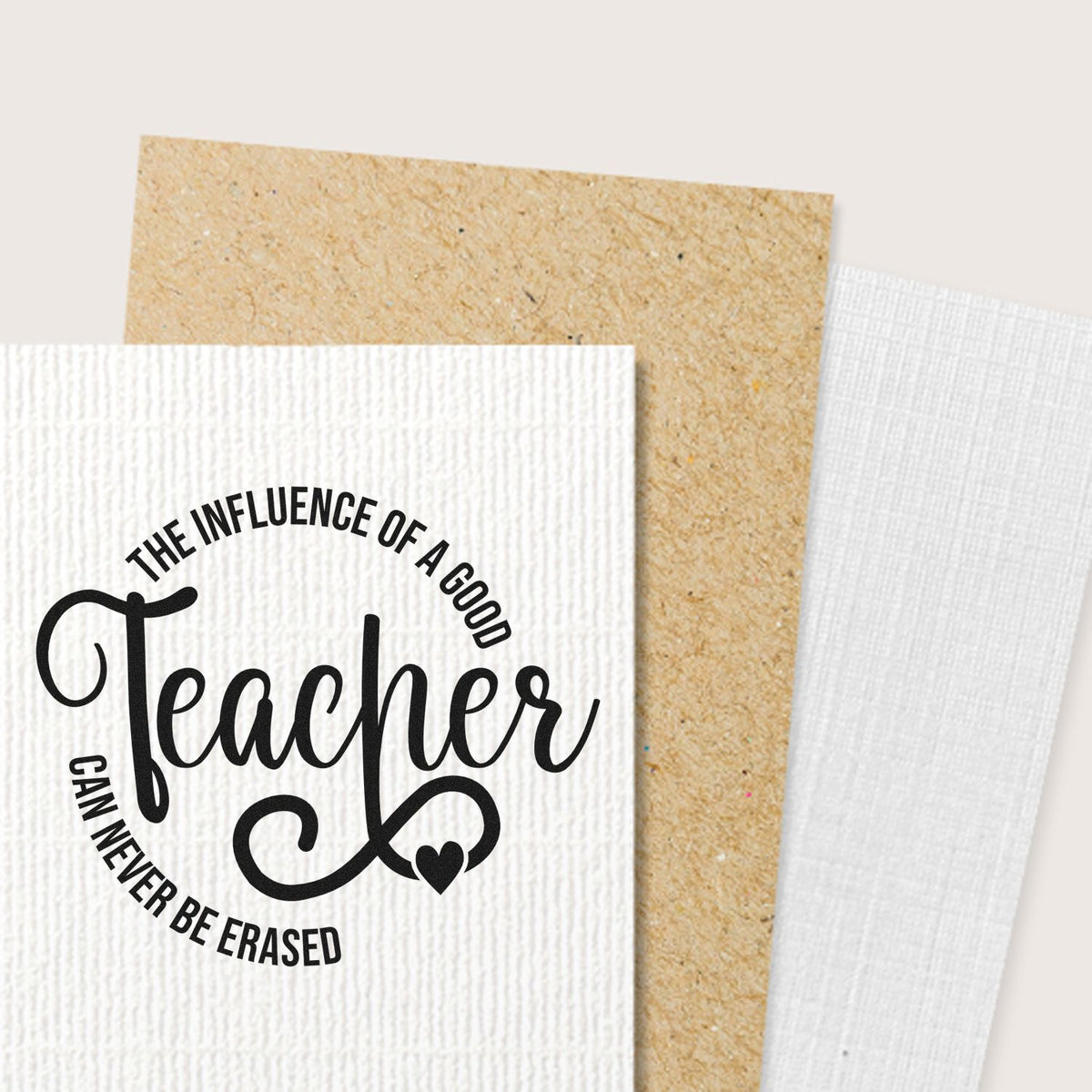 Teacher rubber stamp design with The influence of a good teacher can never be erased on textured cardstock.