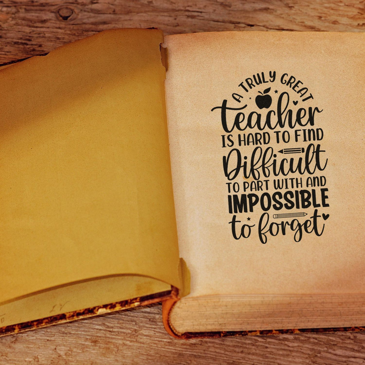 Teacher appreciation rubber stamp on an open book page, featuring a heartfelt quote for a truly great teacher.