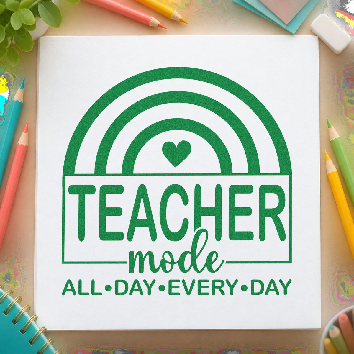 Teacher Mode Rainbow craft stamp imprint in green ink on a handmade project, one idea being daily planner pages.