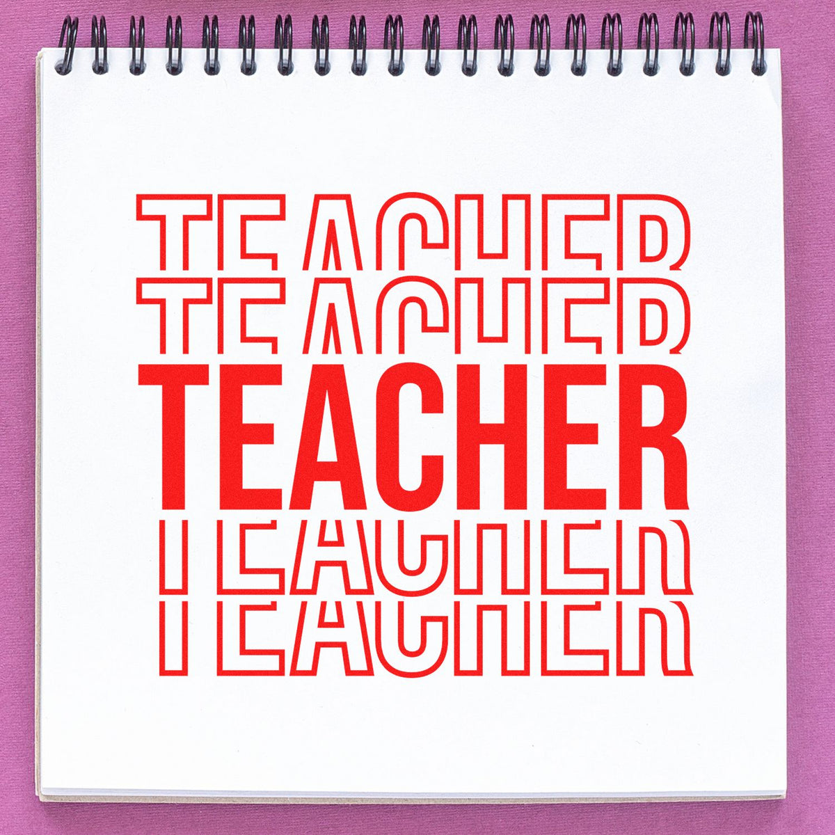 Red TEACHER rubber stamp design repeated on a spiral notebook page for classroom use.