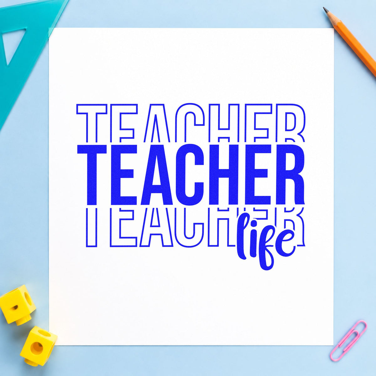 Teacher Life Outline Stack craft stamp imprinted in blue ink on paper, a design suited to shop booth labels.