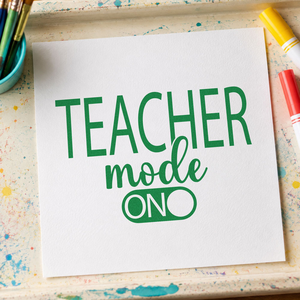 Teacher Mode On craft stamp imprint in green ink on a handmade project, one idea being framed makerspace wall.
