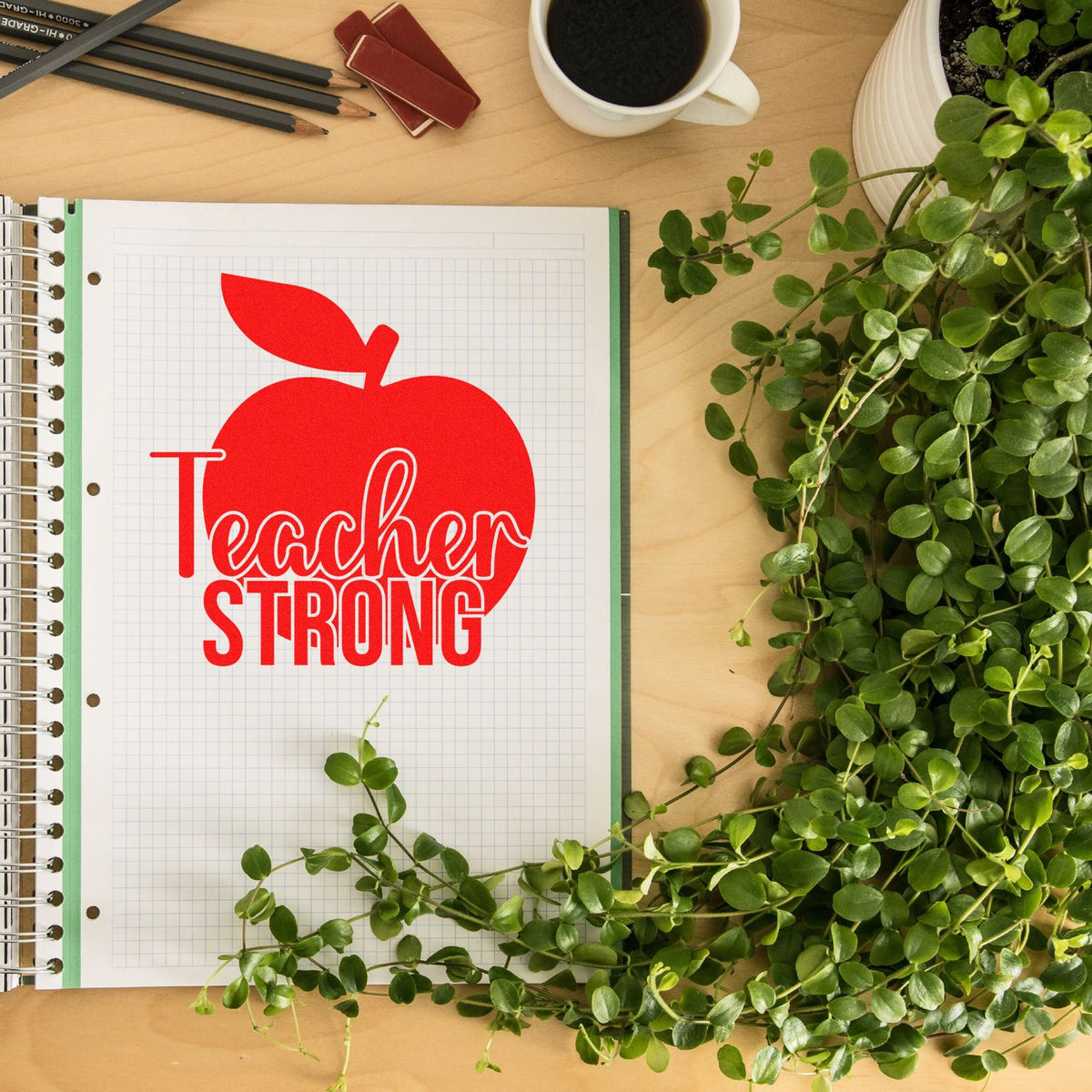 Teacher Strong apple rubber stamp design mockup on notebook, ideal for teacher appreciation crafts.