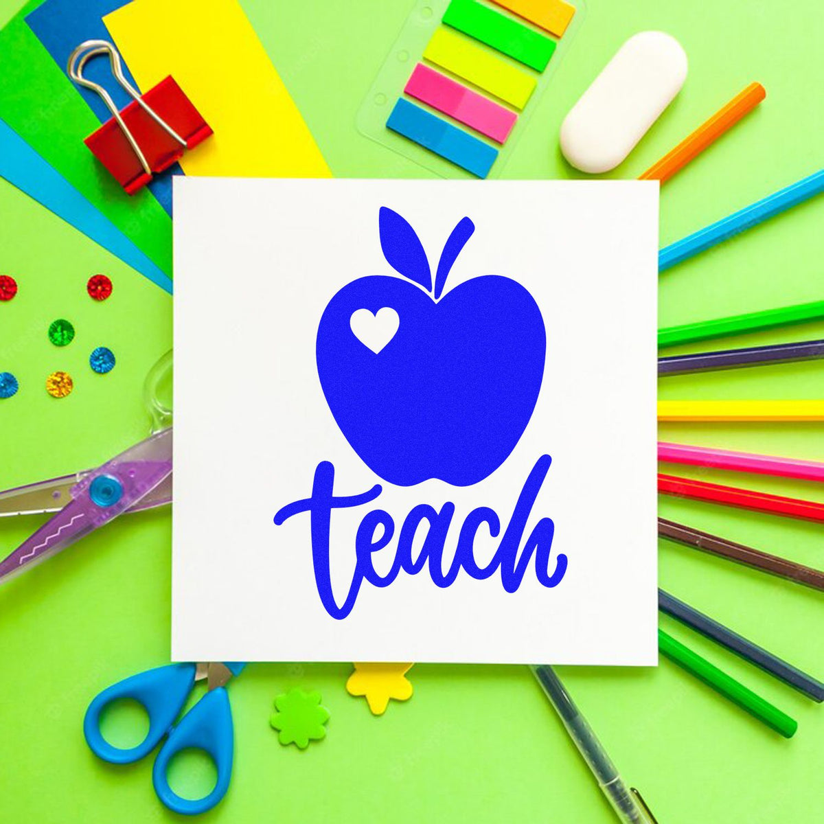Teacher rubber stamp design with blue apple and heart, featuring the word teach on a colorful classroom supplies background.