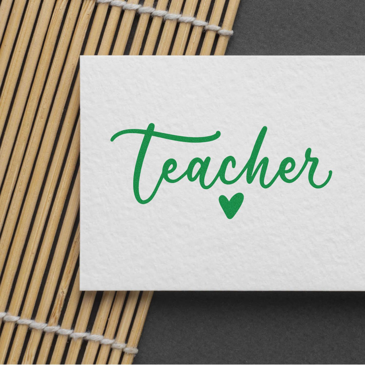 Teacher rubber stamp impression in green script with heart, ideal for classroom notes and teacher appreciation gifts.