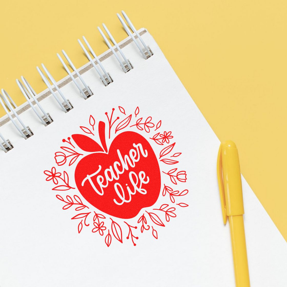 Teacher Life apple rubber stamp design on a notebook, perfect for classroom crafts, teacher planners, and gift ideas.