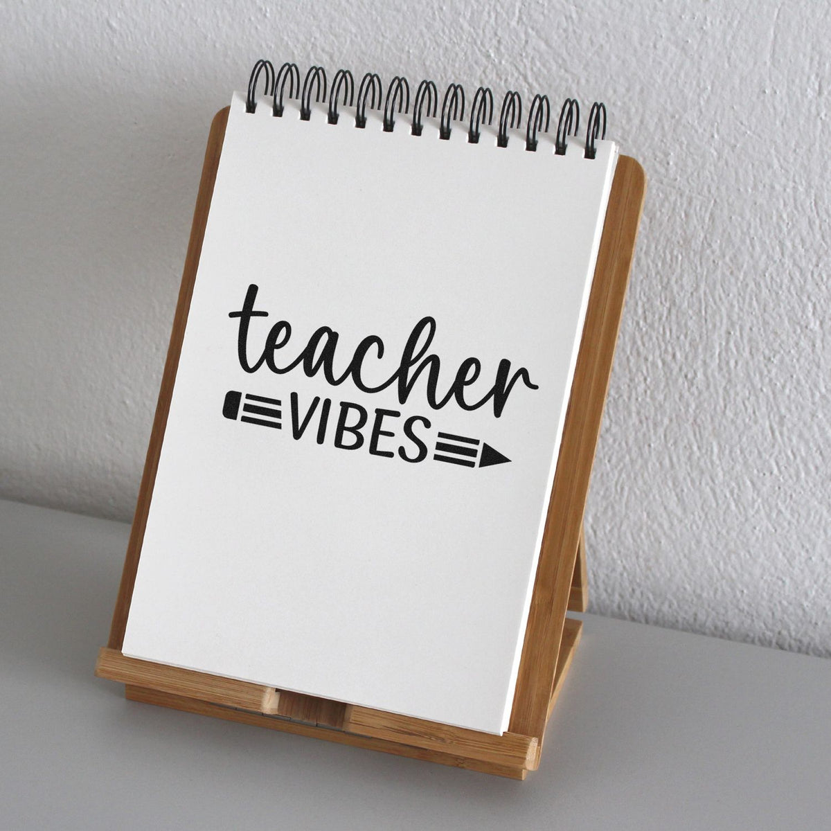 Teacher Vibes rubber stamp design on a spiral notebook display, perfect for classroom gifts and craft projects.