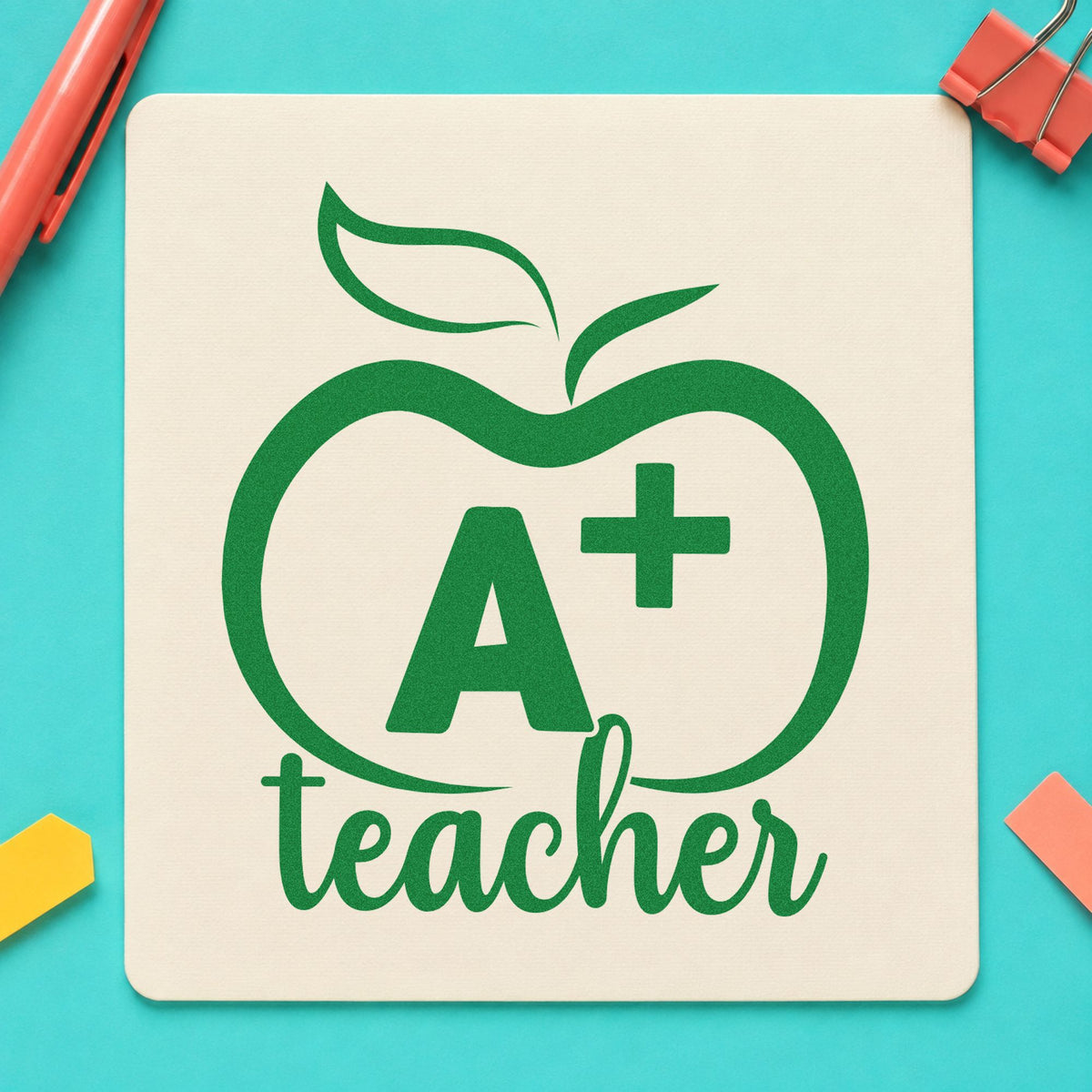 A Plus Teacher Outline Apple craft stamp imprint in green ink on a handmade project, one idea being transcript cover pages.