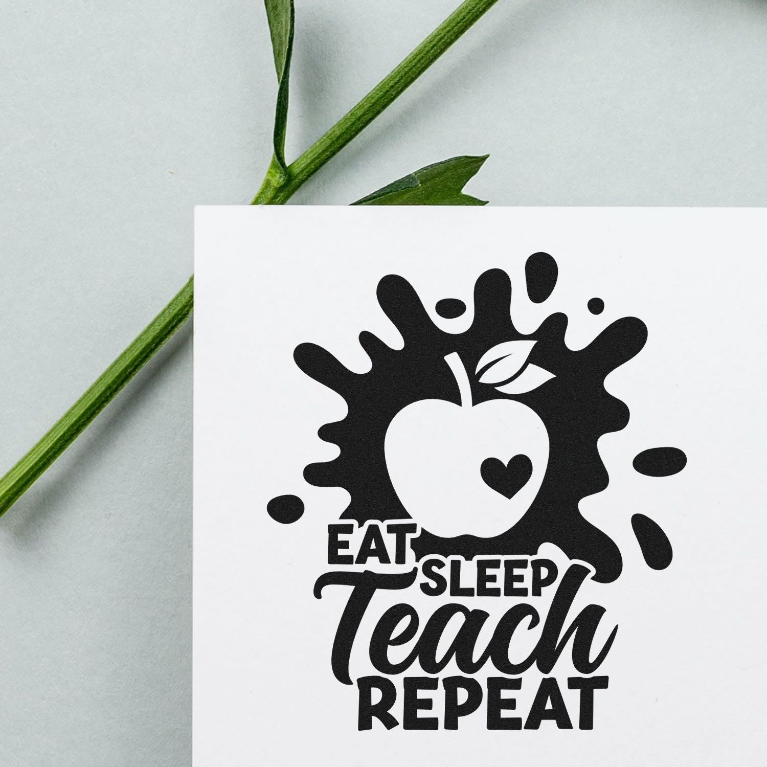 Custom teacher rubber stamp design with apple icon and slogan Eat Sleep Teach Repeat for classroom crafts.