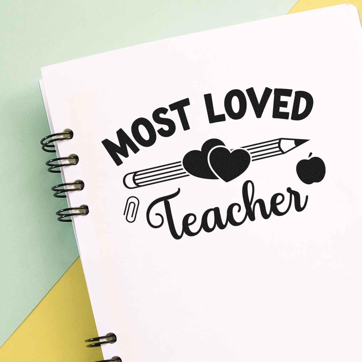 Most Loved Teacher rubber stamp design with pencil, hearts and apple, ideal for teacher appreciation and classroom use.