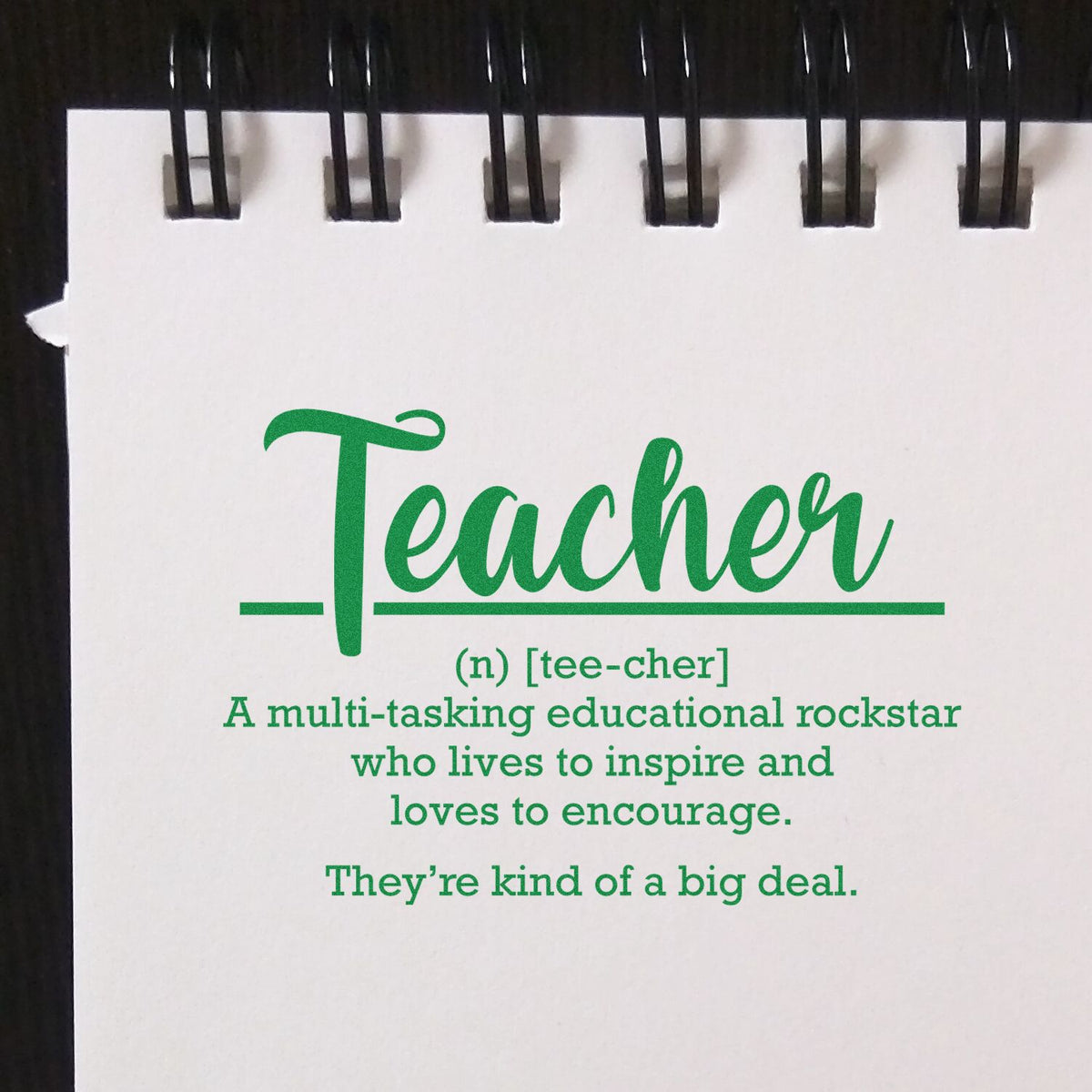 Teacher rubber stamp with inspirational definition for educators, celebrating multitasking, encouragement, and classroom impact.
