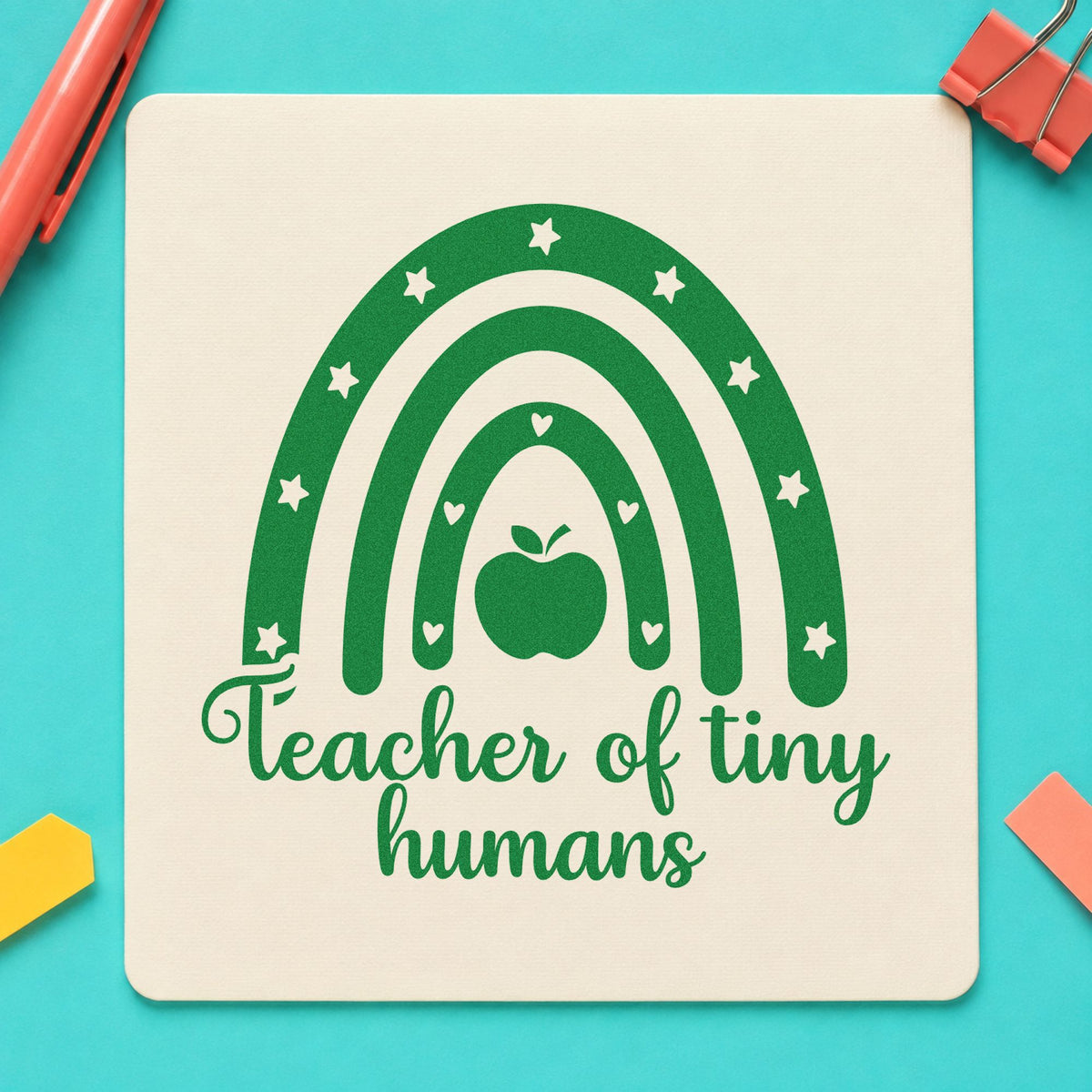 Teacher of Tiny Humans Rainbow craft stamp imprint in green ink on a handmade project, one idea being milestone book pages.