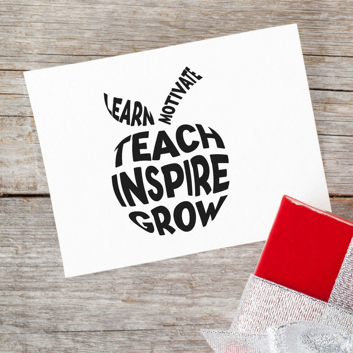 Motivational teacher rubber stamp imprint reading Learn, Motivate, Teach, Inspire, Grow on white paper.