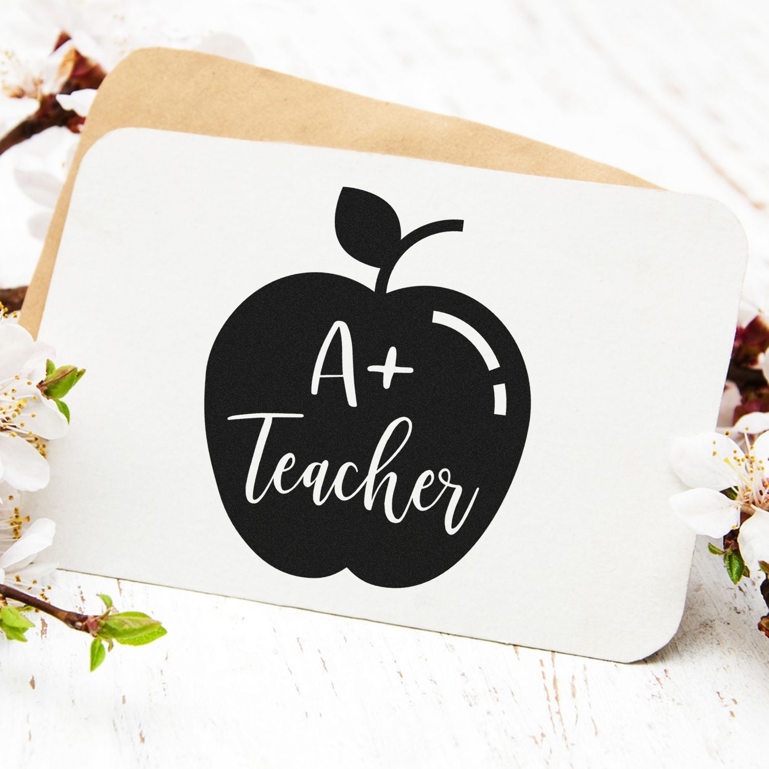 A+ Teacher apple-shaped rubber stamp design for teacher appreciation cards, classroom crafts, and scrapbooking.
