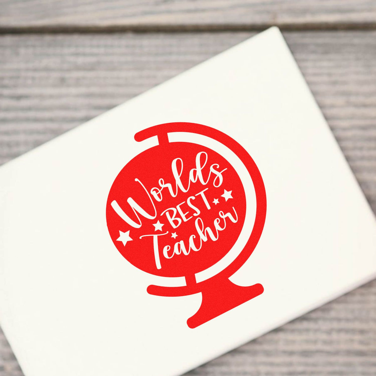 Red World's Best Teacher rubber stamp design on white paper, ideal for teacher appreciation gifts and custom stamping.