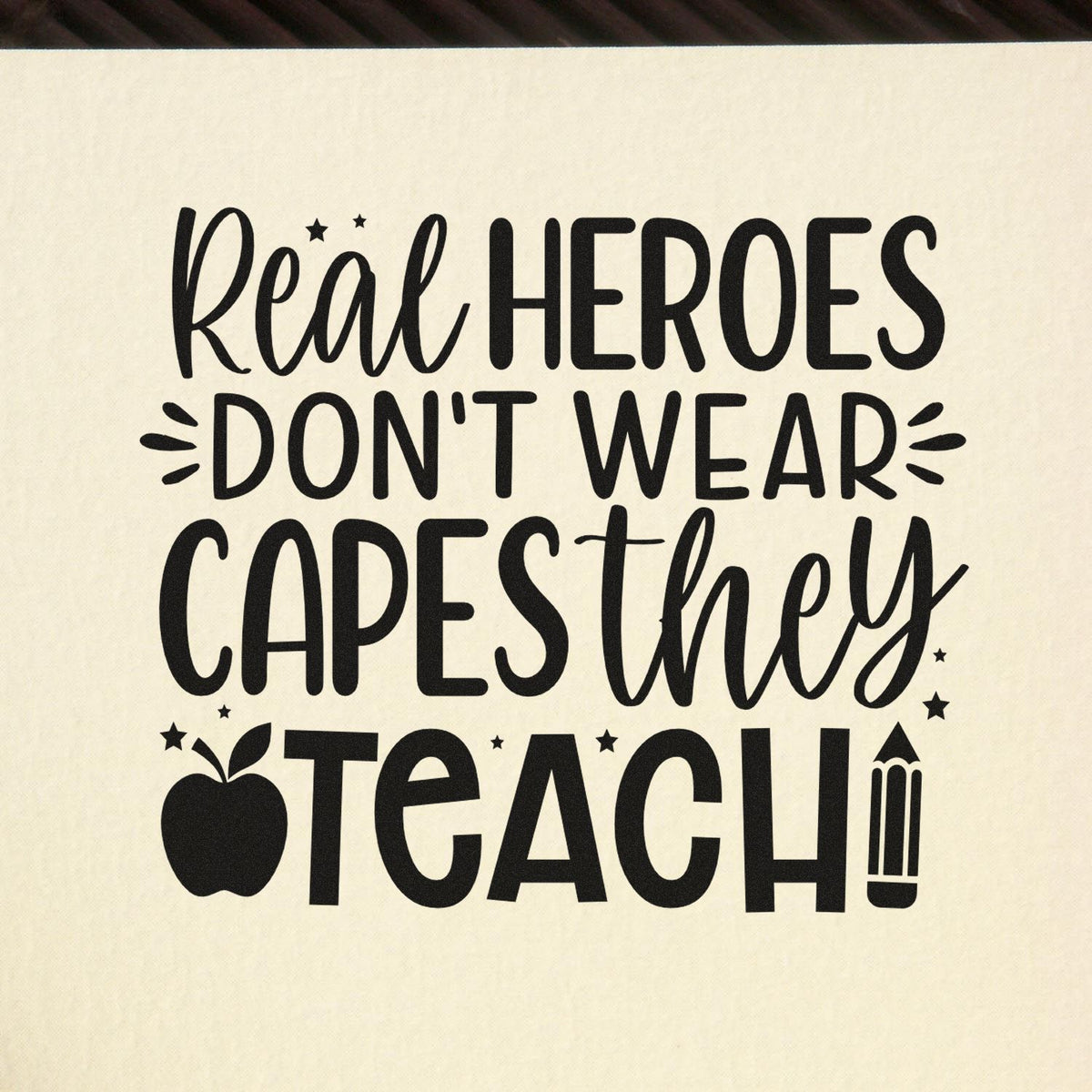 Teacher rubber stamp design with quote Real heroes dont wear capes, they teach with apple and pencil accents.