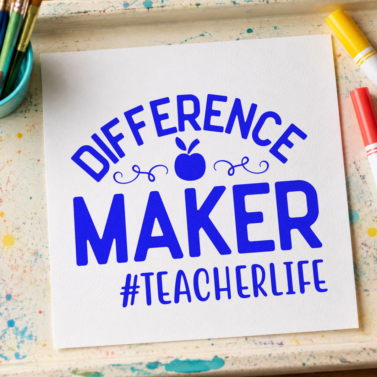 Difference Maker Teacher Life craft stamp imprinted in blue ink on paper, a design suited to nomination seals.