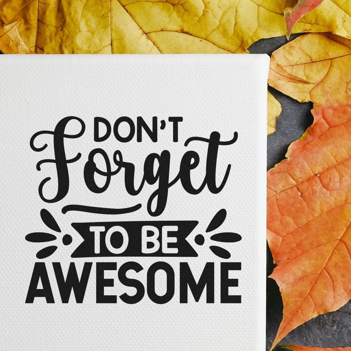 Inspirational rubber stamp design with Dont forget to be awesome message on white card with autumn leaves background.