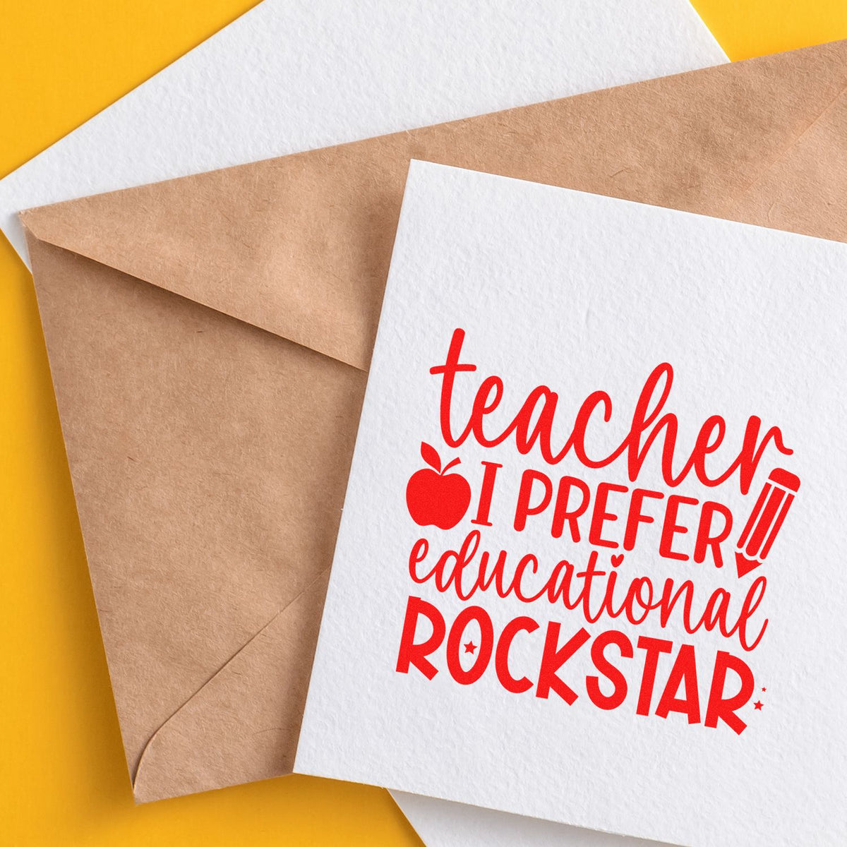 Teacher I Prefer Educational Rockstar rubber stamp design on a greeting card with kraft envelopes on a yellow background.
