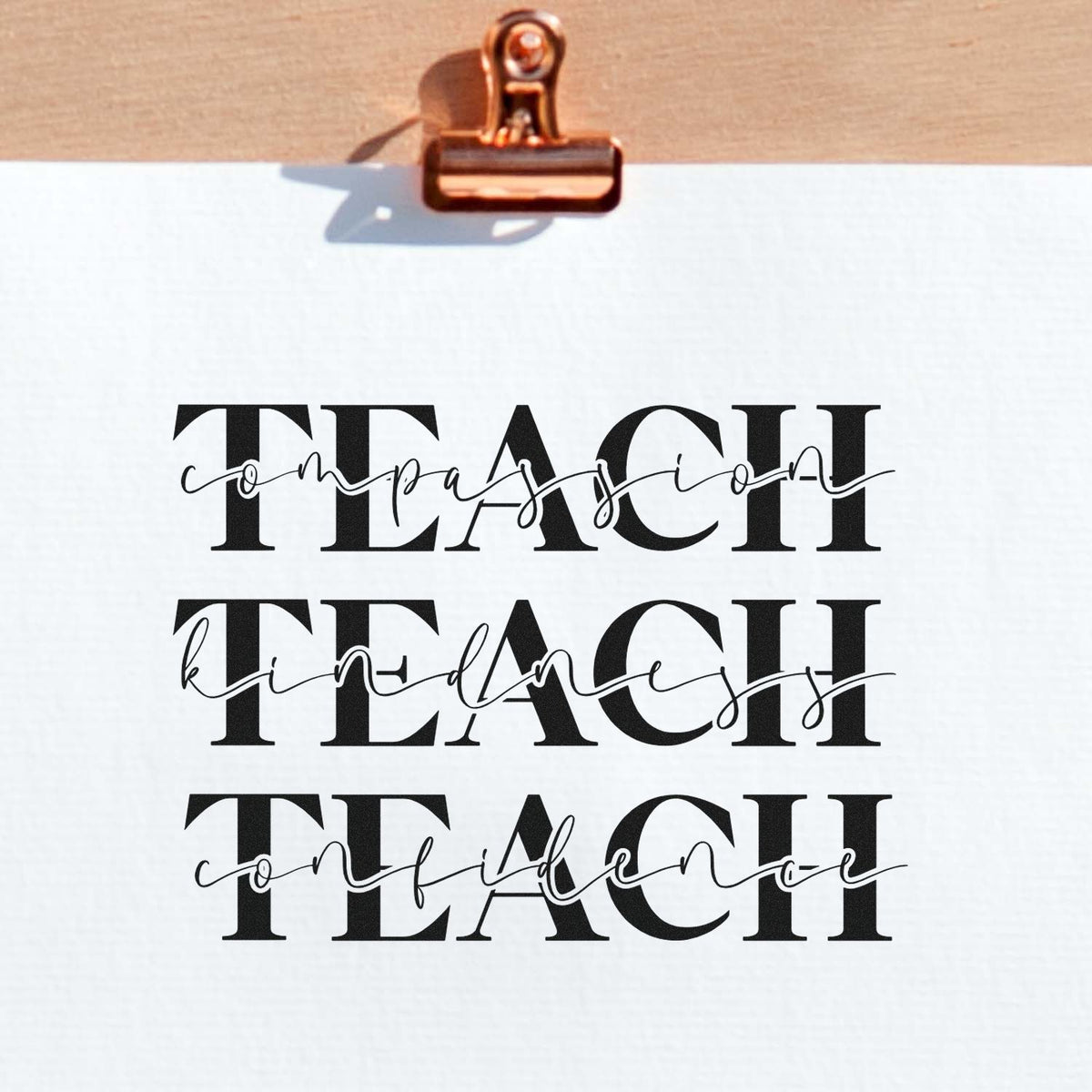 Teacher rubber stamp design with bold TEACH lettering and script words compassion, kindness, and confidence on paper.