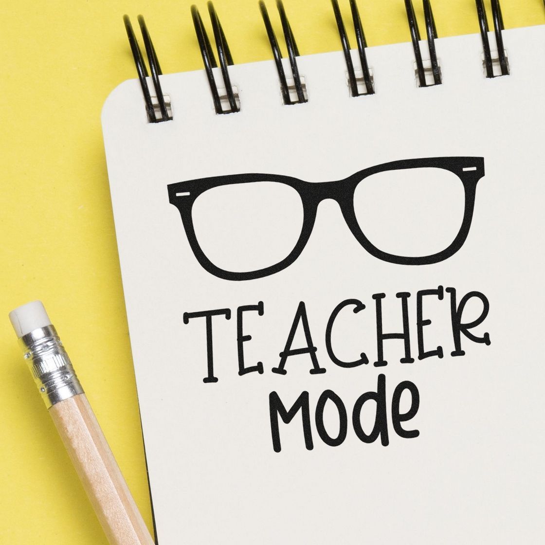 Teacher Mode rubber stamp design with glasses icon on notebook, perfect for classroom stationery, teacher gifts, and custom stamps.