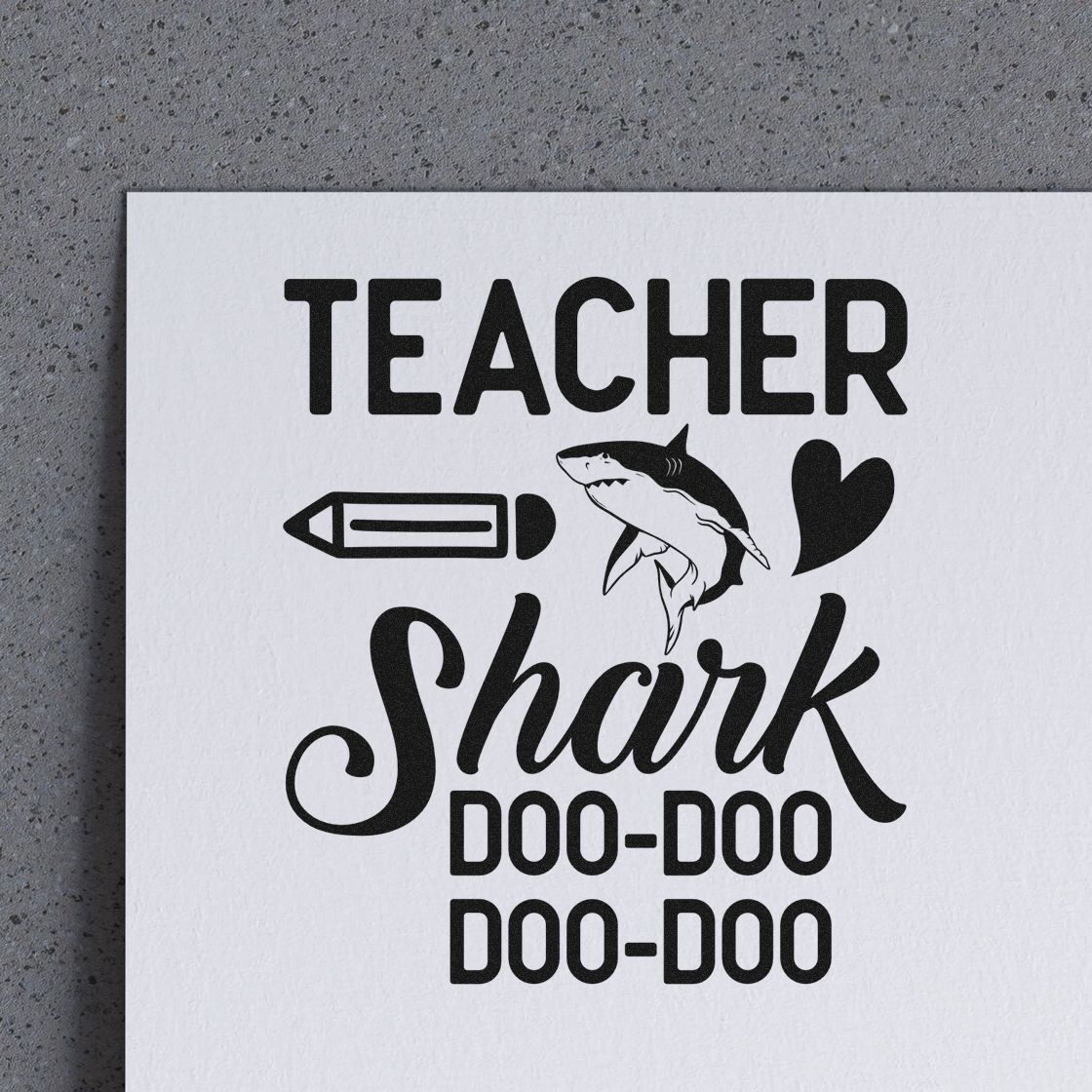 Teacher shark pun rubber stamp design with pencil, heart, and shark graphic, reading Doo-Doo Doo-Doo.