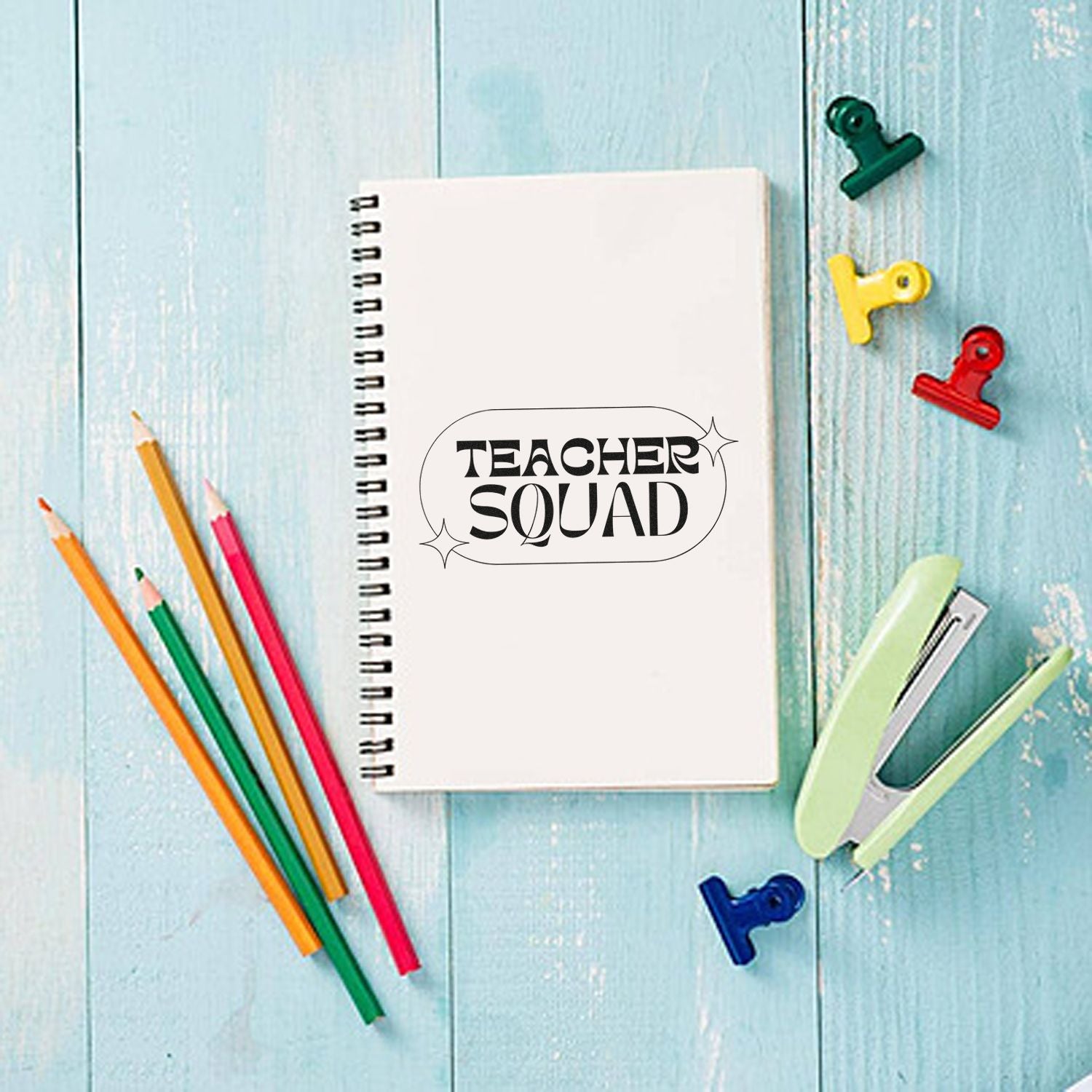 Teacher Squad rubber stamp on spiral notebook, styled with pencils and clips for teacher gift or classroom branding.