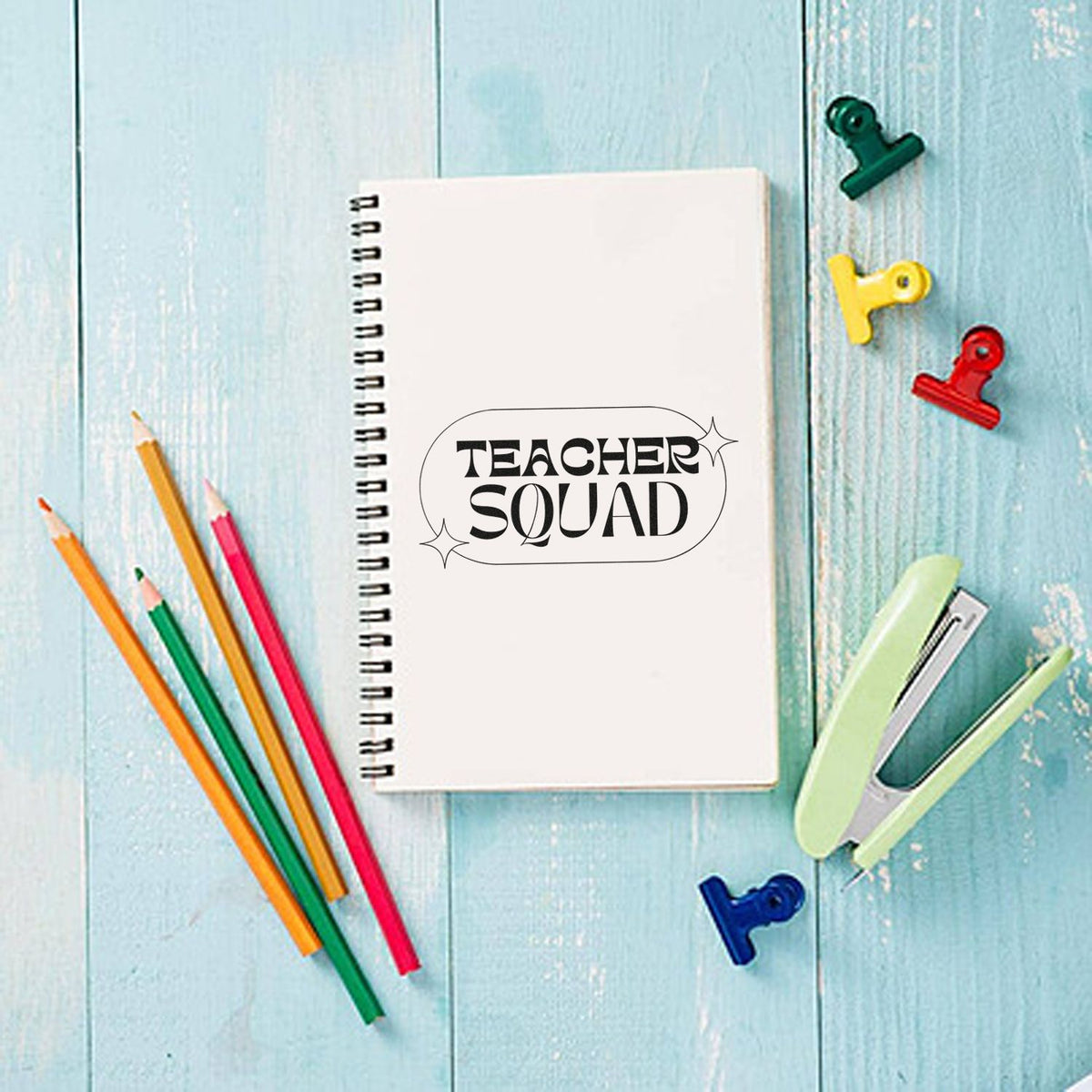 Teacher Squad rubber stamp on a spiral notebook, perfect for classroom crafts, teacher gifts, and school supply branding.