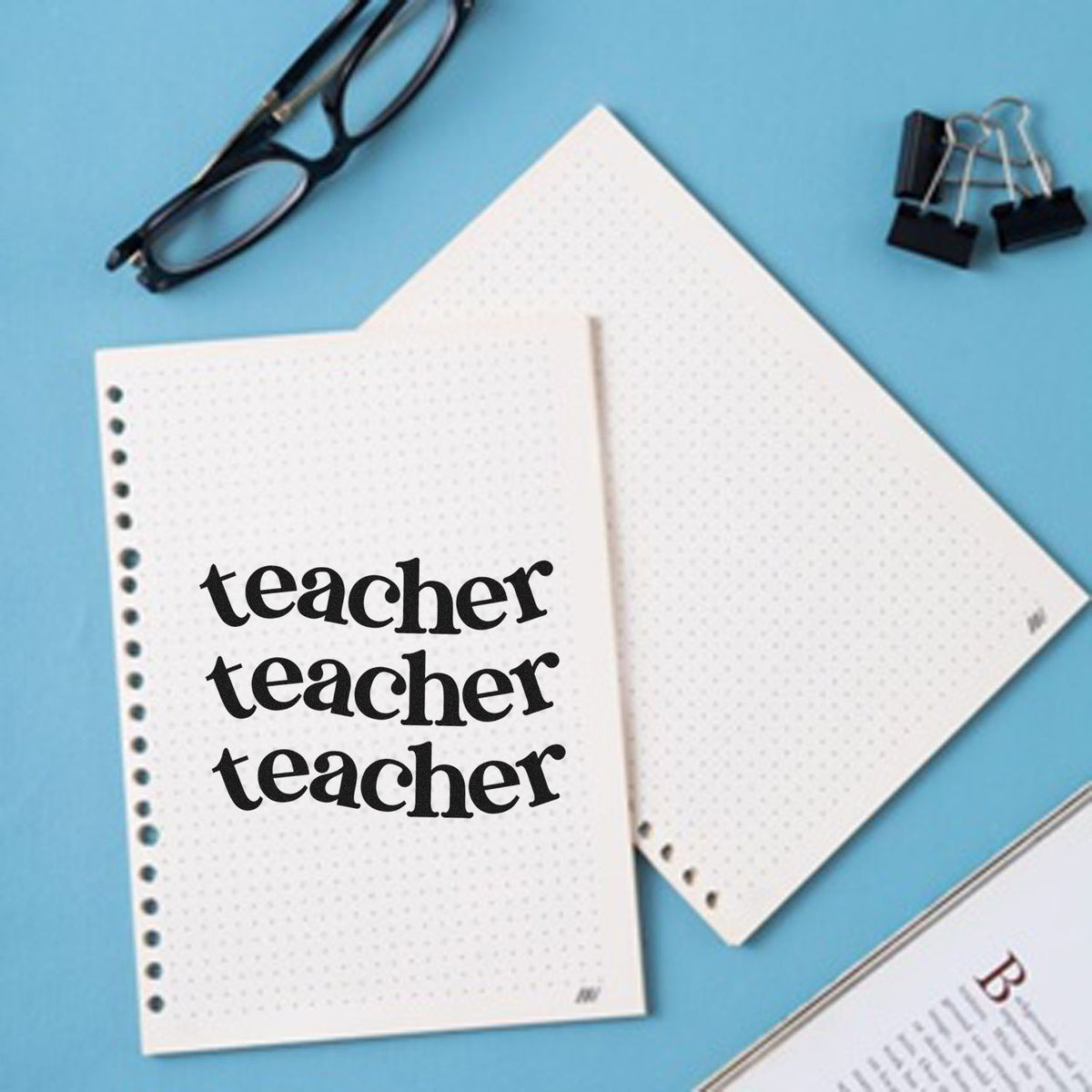 Teacher rubber stamp printed on dotted notebook pages for classroom planning and teacher journaling.