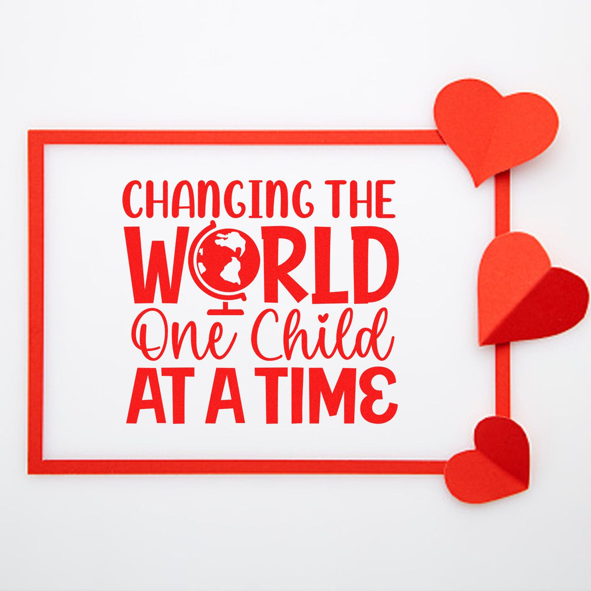 Red rubber stamp design with hearts and Changing the World One Child at a Time slogan for teachers, schools, or nonprofits.