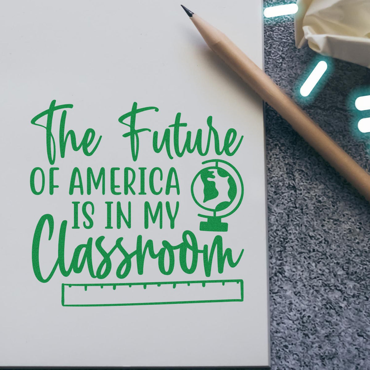 Teacher rubber stamp design reading The Future of America is in My Classroom with globe icon and pencil.