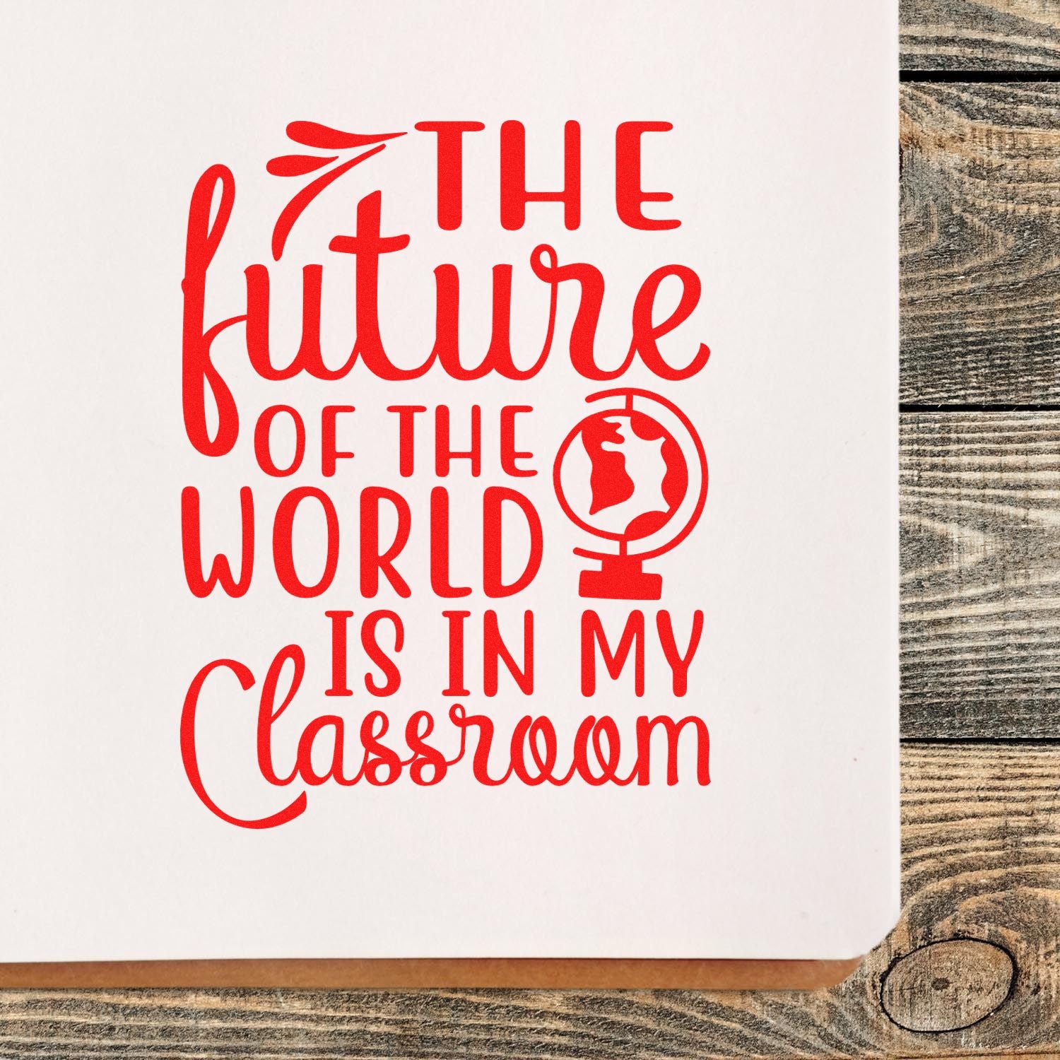 Red rubber stamp impression reading The future of the world is in my classroom, with globe icon for teacher classroom crafts.