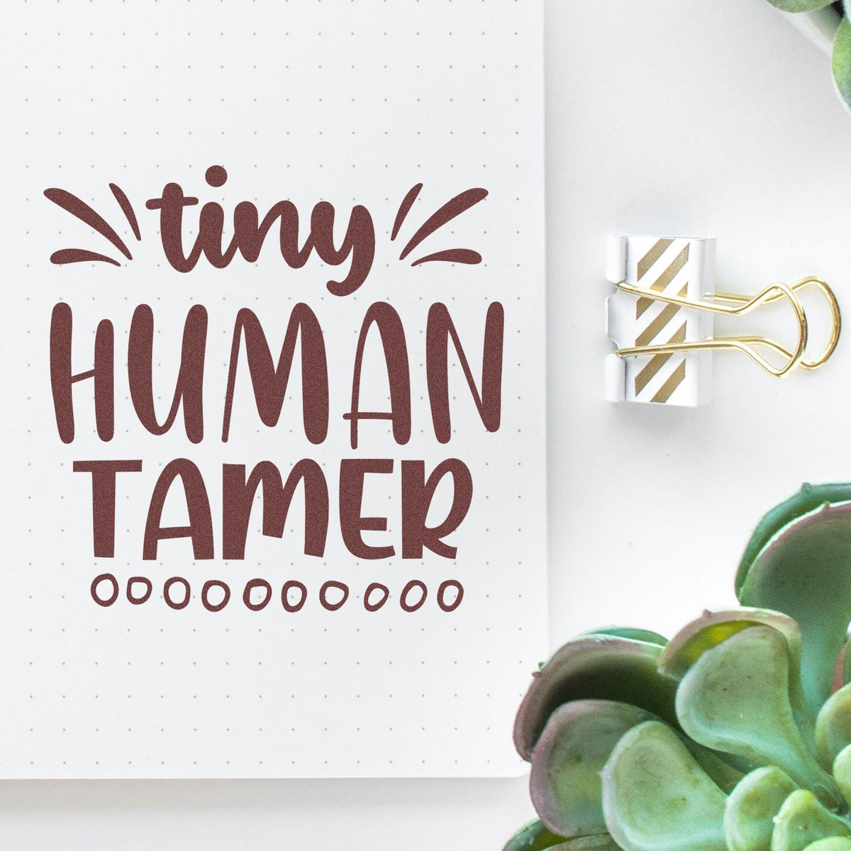 Tiny Human Tamer rubber stamp design on notebook page, perfect for planners, journals, and craft projects.