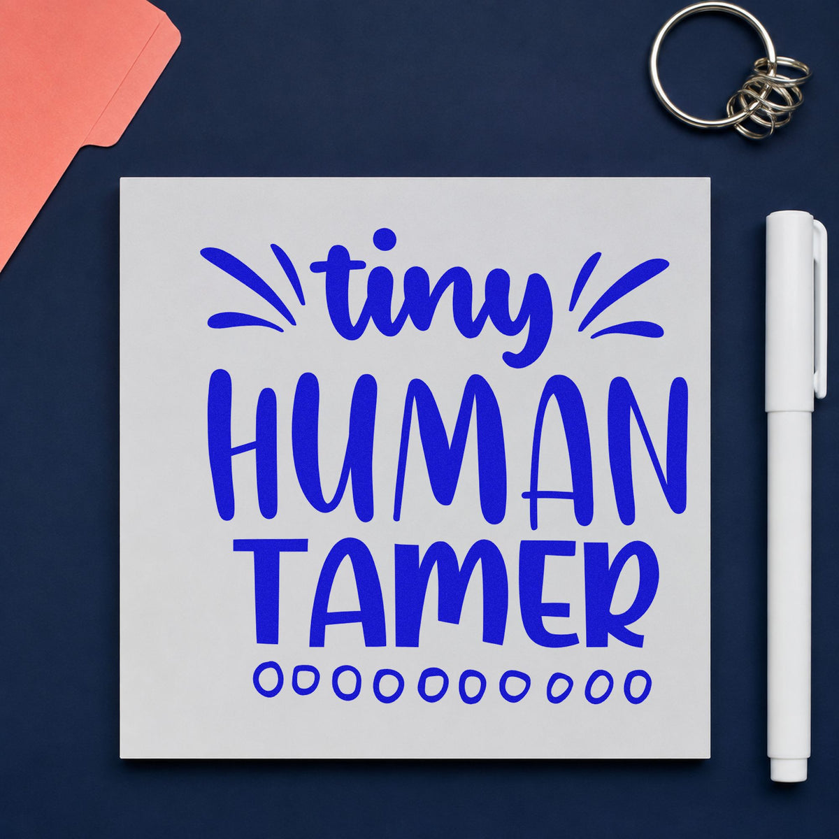 Tiny Human Tamer Lettering craft stamp imprinted in blue ink on paper, a design suited to snack bag seals.