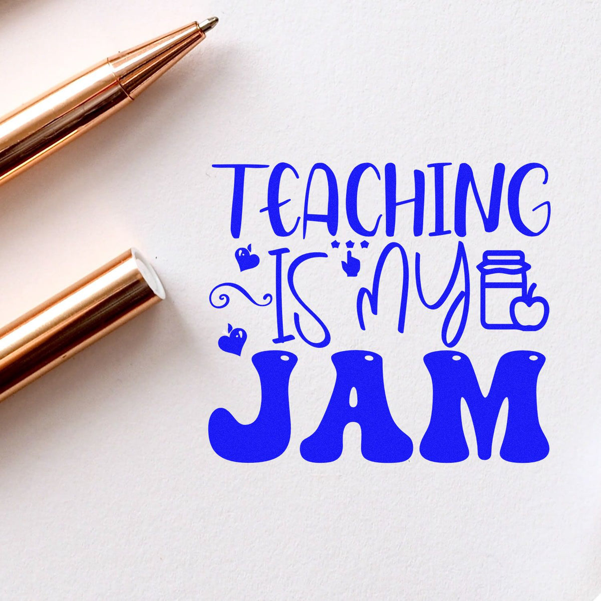 Teaching is my JAM rubber stamp design with blue lettering and pens, ideal for teacher crafts and classroom stationery.