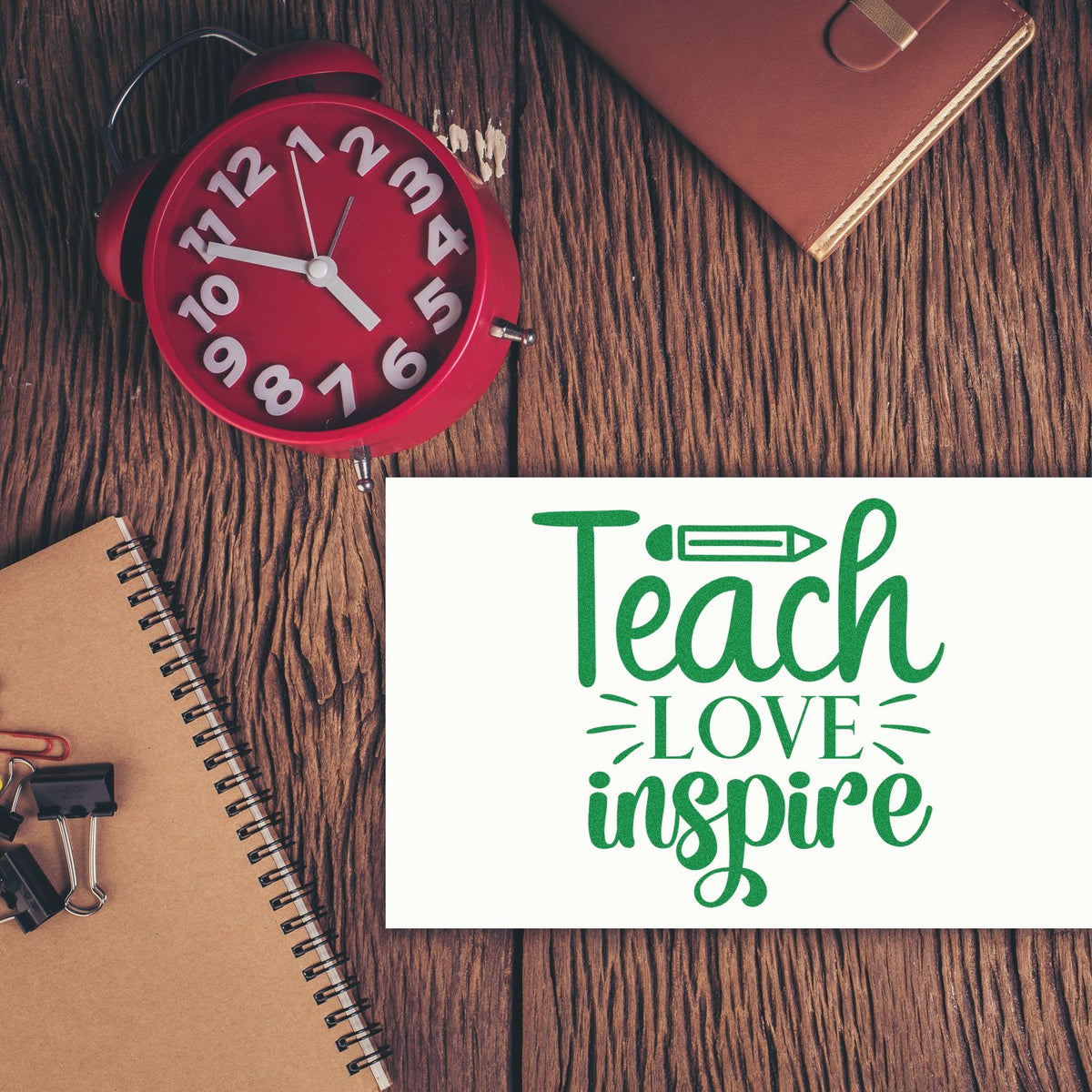 Teach Love Inspire teacher rubber stamp design with school supplies on a desk, ideal for classroom crafting and teacher gifts.