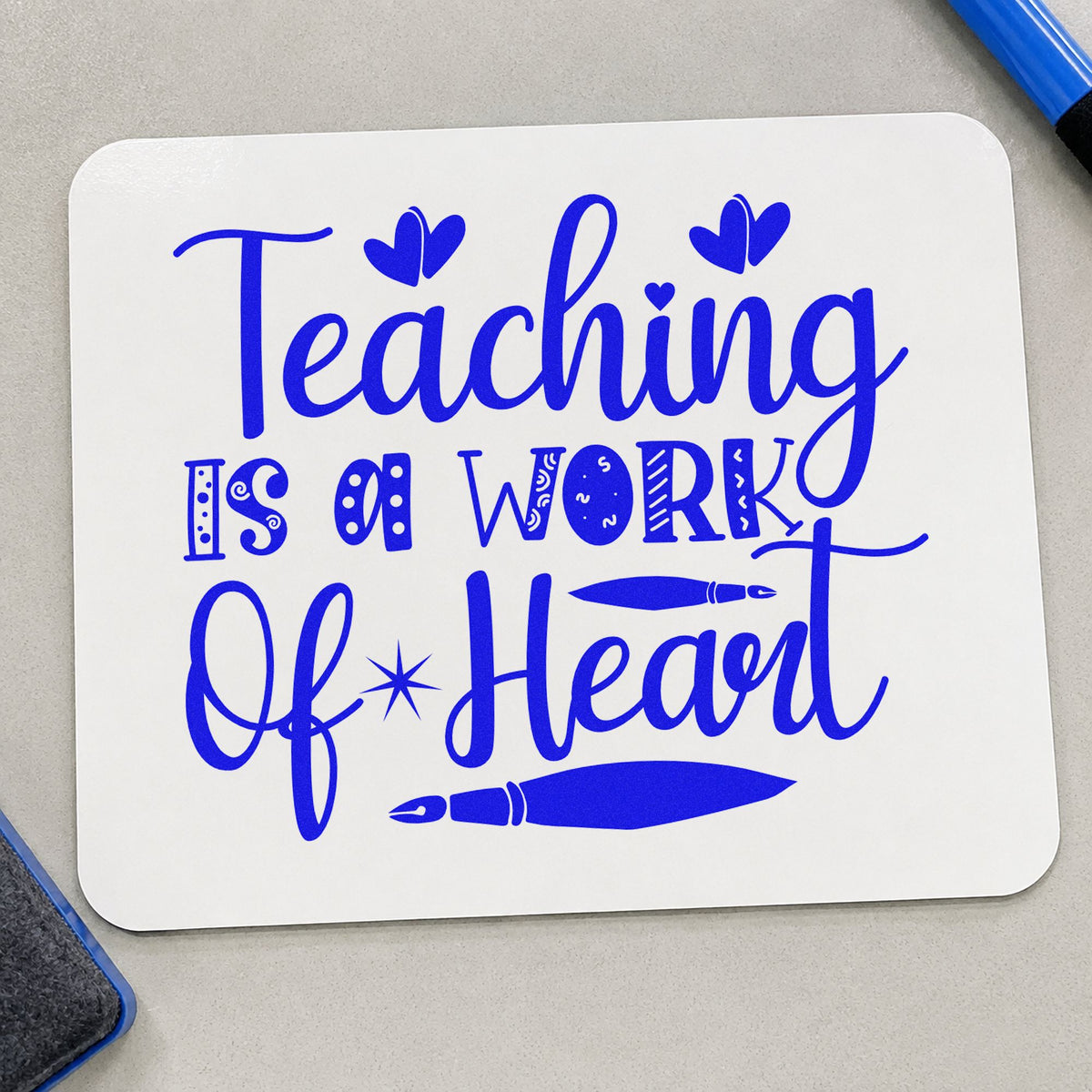 Teaching Work Of Heart Pens craft stamp imprinted in blue ink on paper, a design suited to portfolio seals.