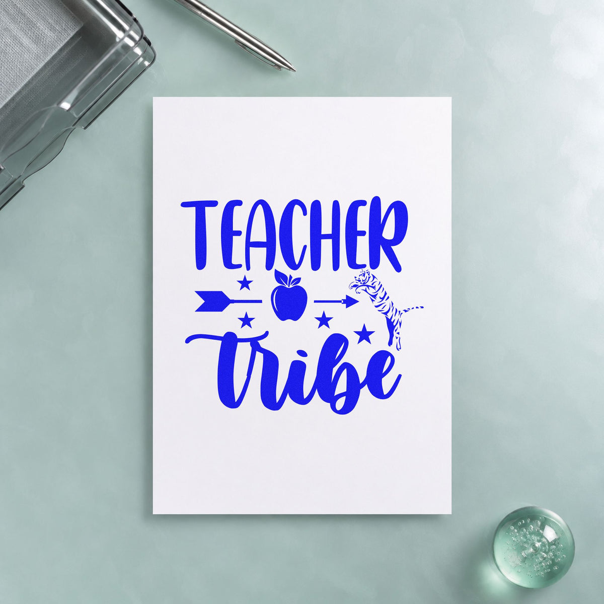 Teacher Tribe Arrow Apple craft stamp in blue ink on cardstock, an easy option for poncho hood panels.