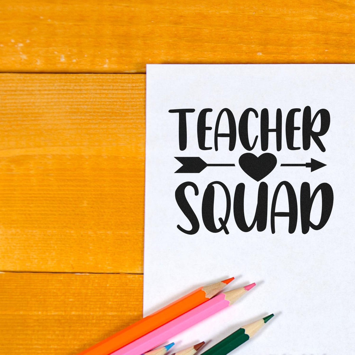 Teacher Squad rubber stamp design on paper with colored pencils, perfect for classroom crafts, teacher gifts, and school projects.