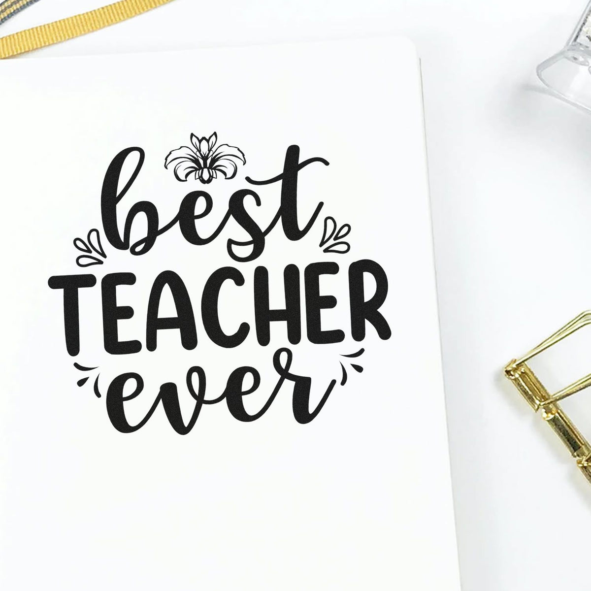 Best Teacher Ever rubber stamp for teacher appreciation crafts, featuring bold script lettering and floral accents on white paper.