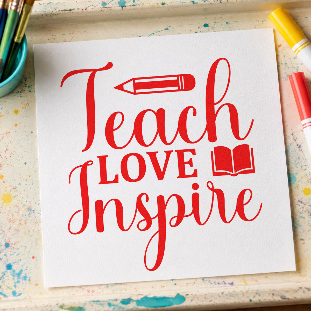 Teach Love Inspire Book rubber stamp shown in red ink, stamped for projects such as reading week notes.