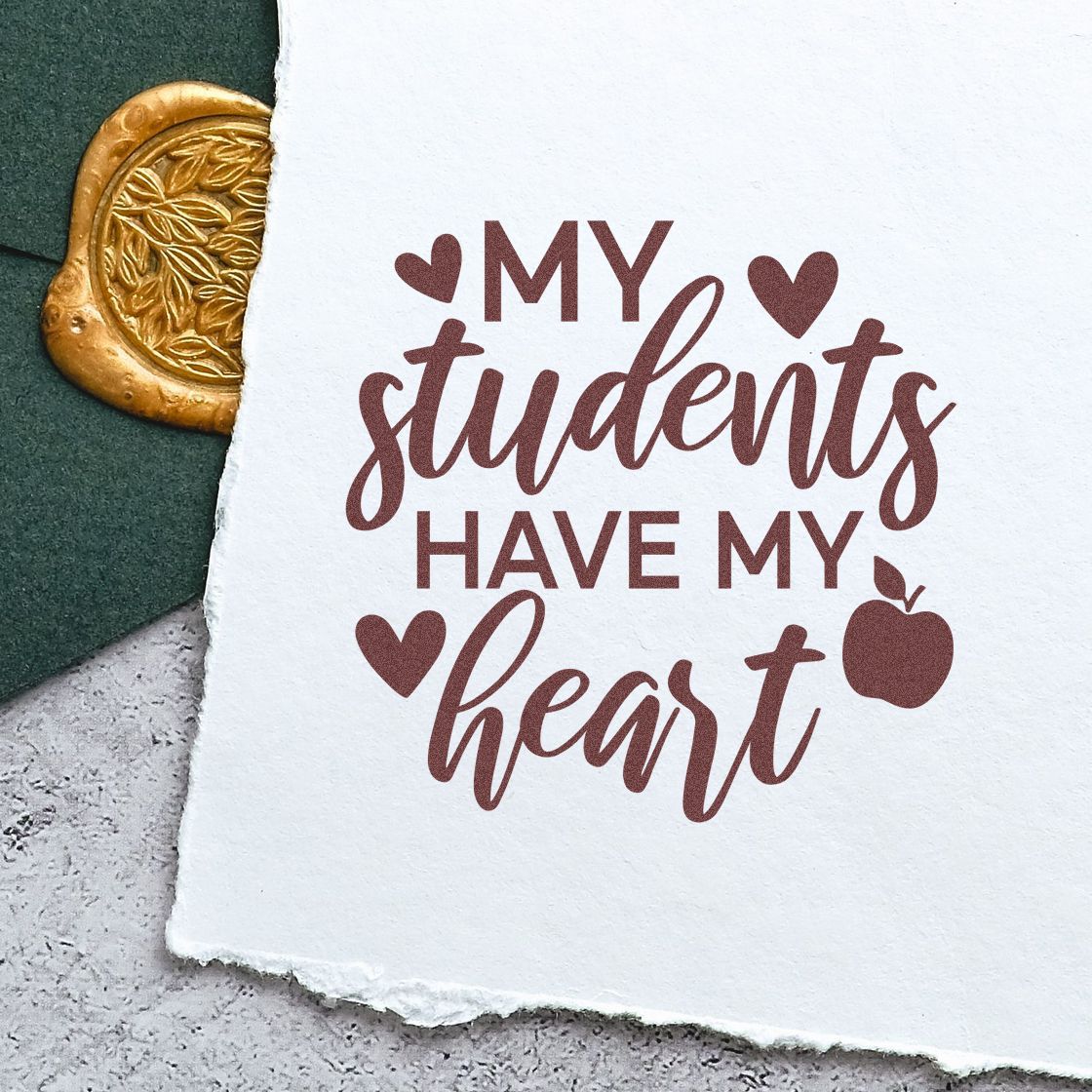 Custom rubber stamp impression reading My students have my heart with hearts and apple design on paper.