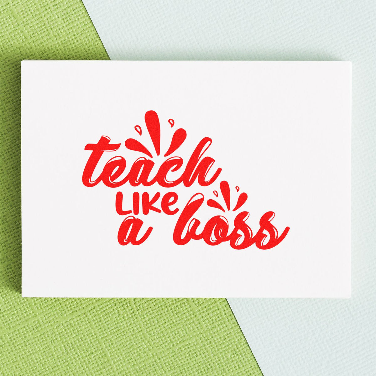 Teacher rubber stamp design reading Teach Like a Boss in red on white card stock.