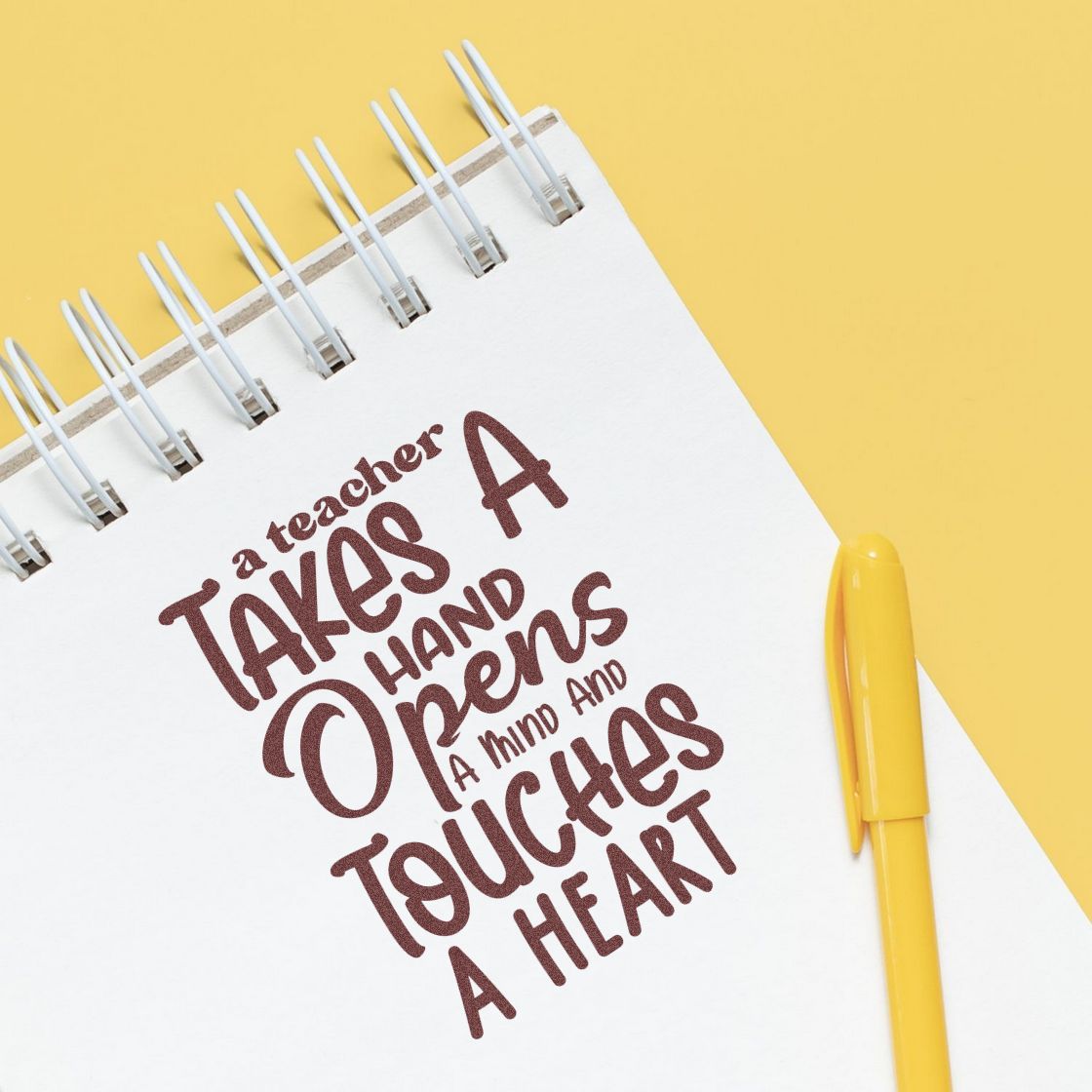 Teacher appreciation rubber stamp design with quote, A teacher takes a hand, opens a mind and touches a heart, on a notebook.