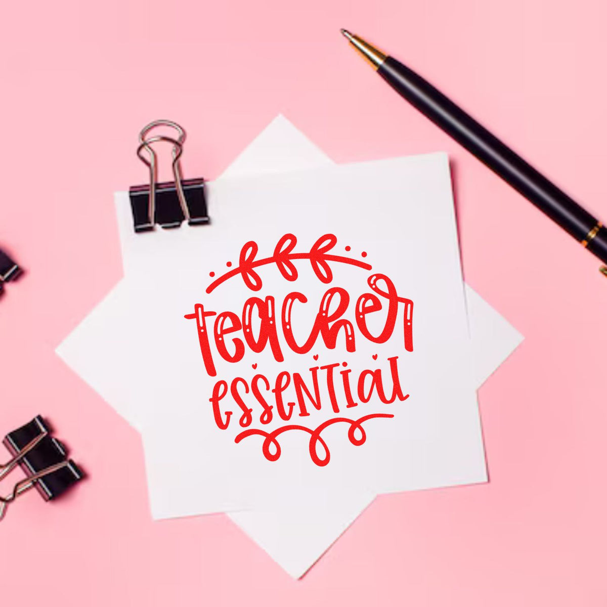 Teacher Essential rubber stamp design on paper with stationery, ideal for classroom crafts, teacher gifts, and scrapbooking.