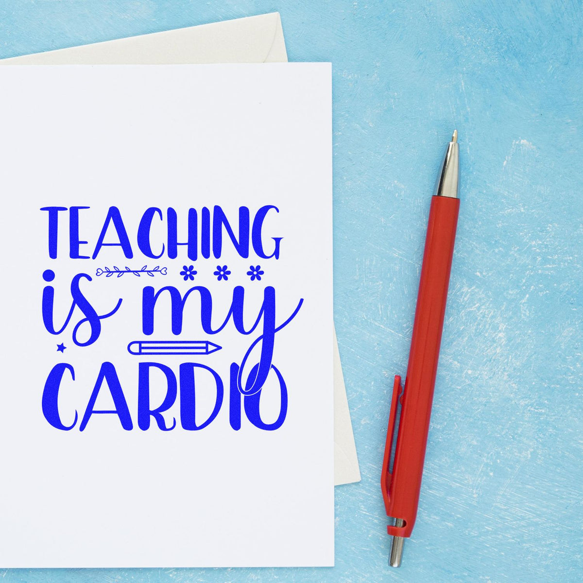Teacher rubber stamp featuring Teaching is my cardio quote on a card, styled with a red pen on a blue background.