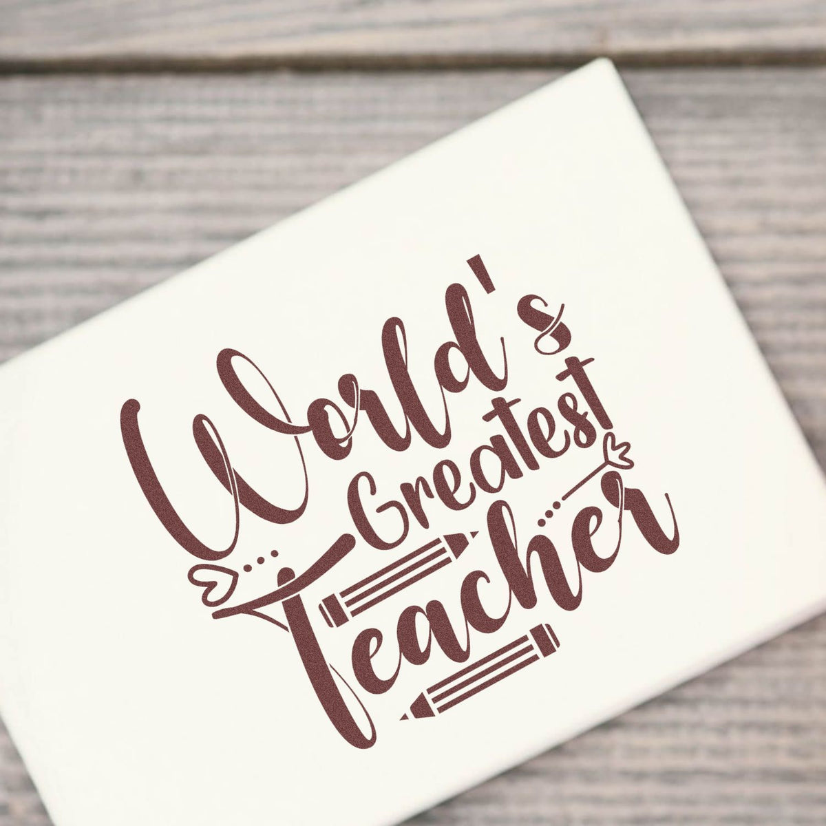 Worlds Greatest Teacher rubber stamp design on a white stamp block, perfect for teacher appreciation gifts and classroom crafts.